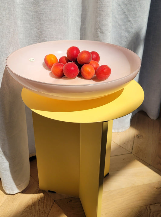 full view of a large vintage opal pink Murano bowl on a yellow side table