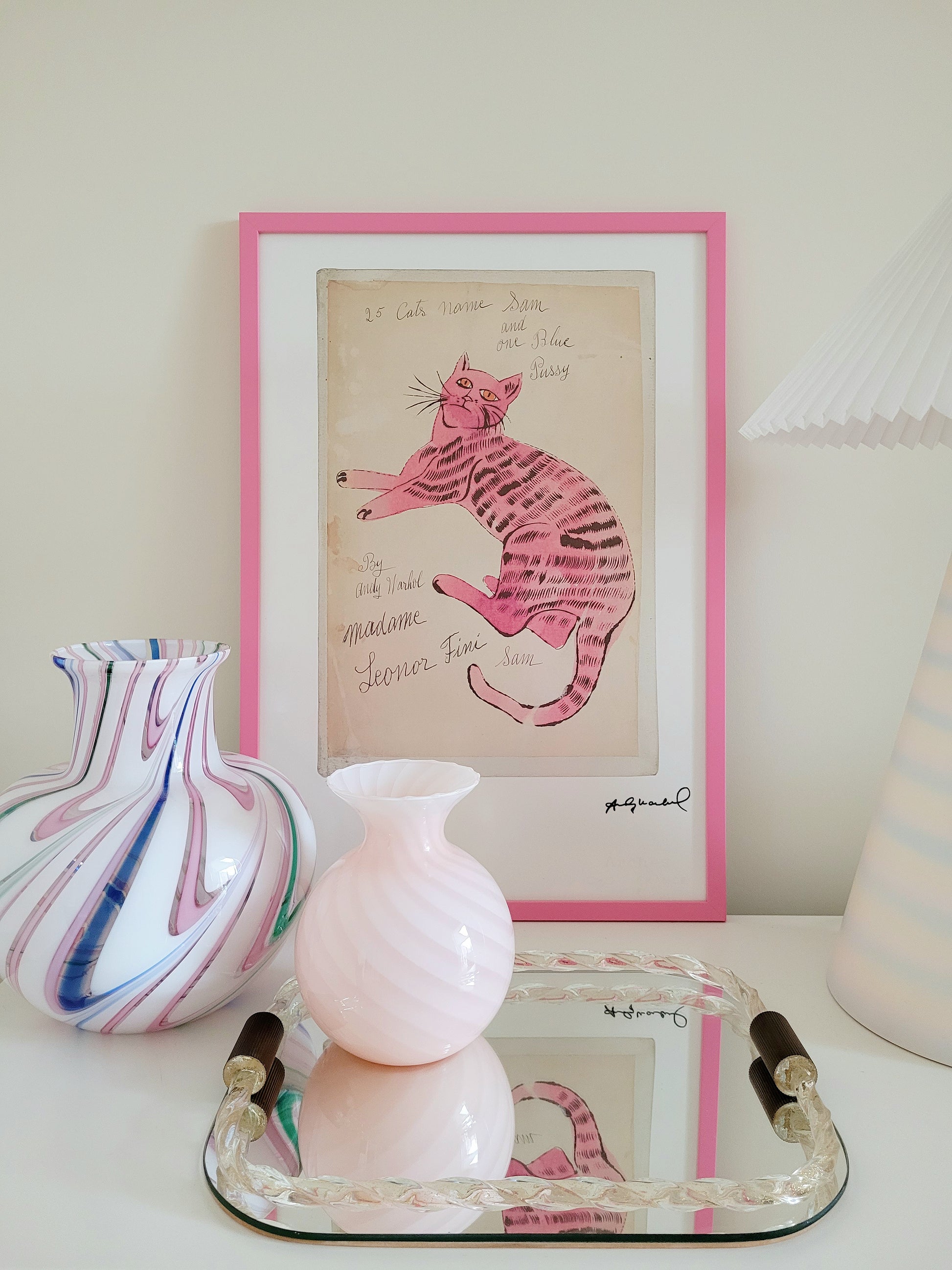 front view of the lithograph cat Sam by Andy Warholl in a pink frame