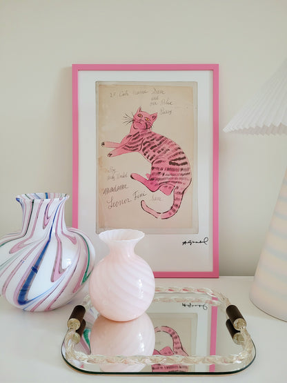 front view of the lithograph cat Sam by Andy Warholl in a pink frame