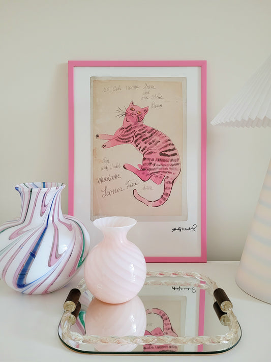 front view of the lithograph cat Sam by Andy Warholl in a pink frame