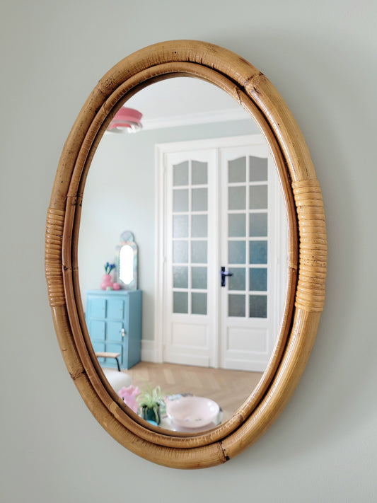 full view of an oval wall mirror in natural bamboo
