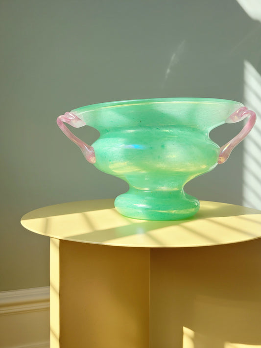 full view of a scavo Murano glass amphora vase in green and pink on a yellow side table