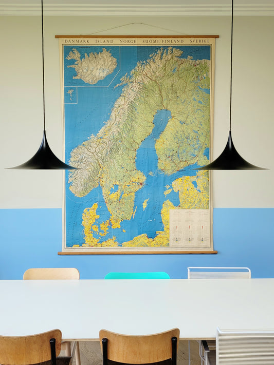 full view of a large historic school map of the Nordic countries hanging on a blue and yellow wall