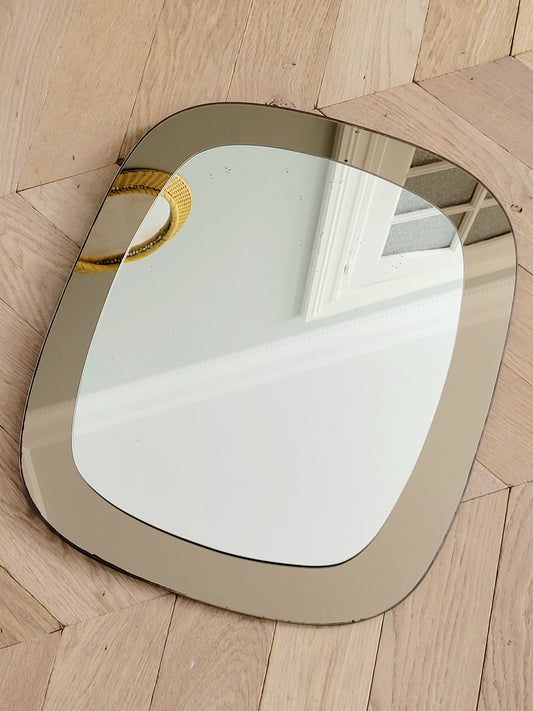 full view of a vintage two-tone Italian wall mirror with smoked glass
