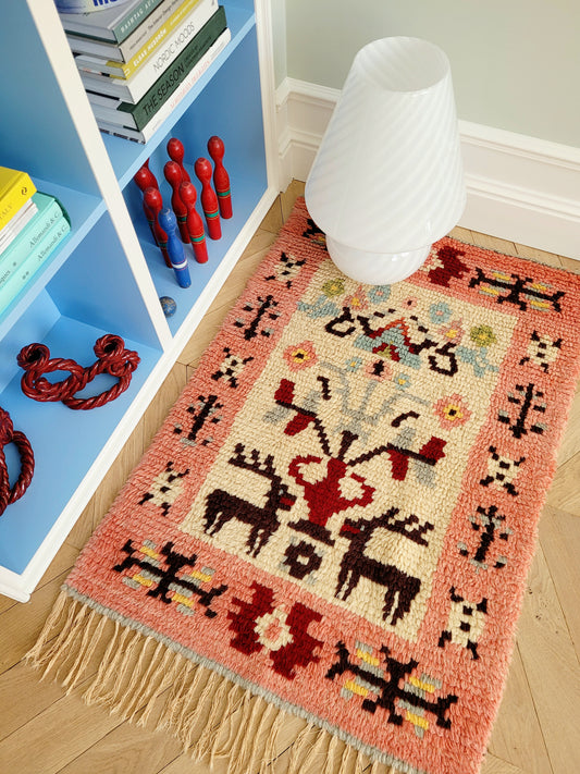 top view of a vintage colourful Scandinavian Rya rug made from wool