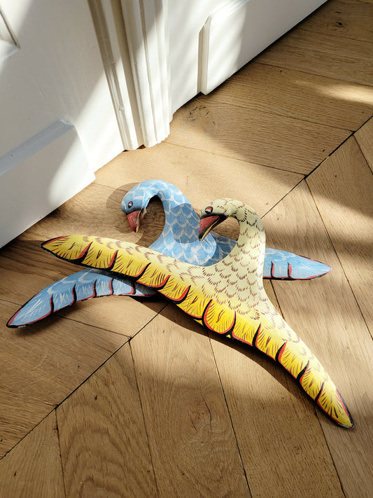 full view of two playful wooden hangers in a bird shape