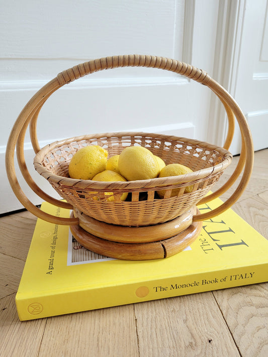 full view of a wicker and rattan fruit basket filled with lemons