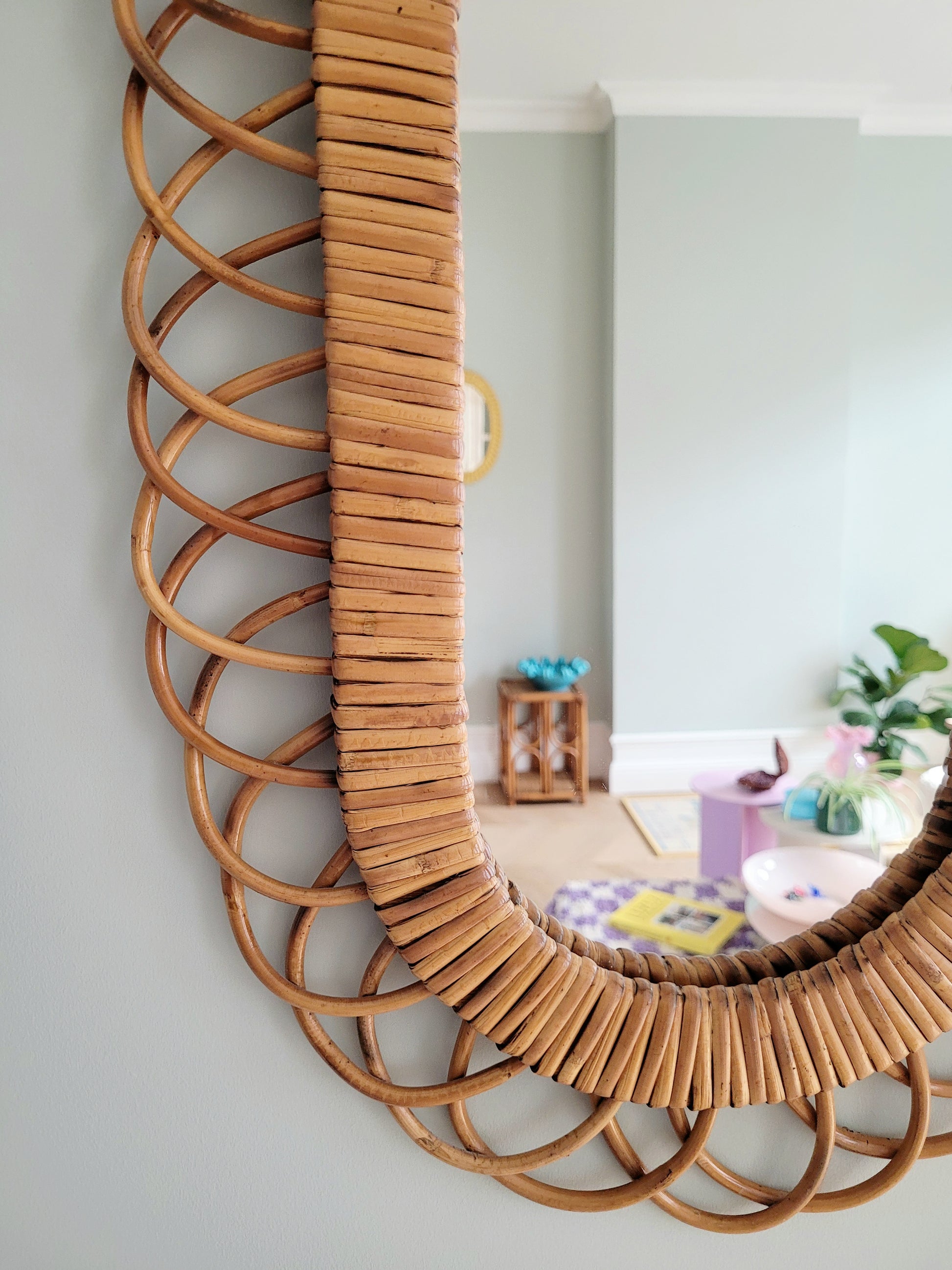 detail of an elongated vintage rattan wall mirror possibly from Franco Albini