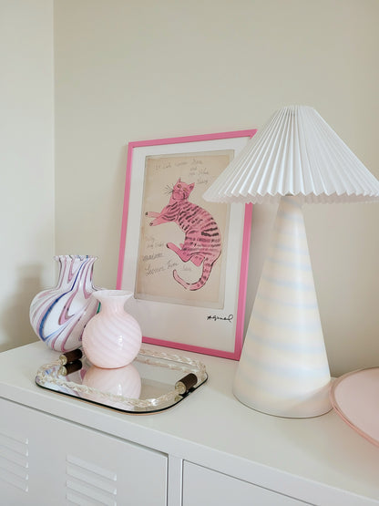 side view of the lithograph cat Sam by Andy Warholl in a pink frame