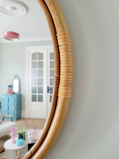 detail of an oval wall mirror in natural bamboo