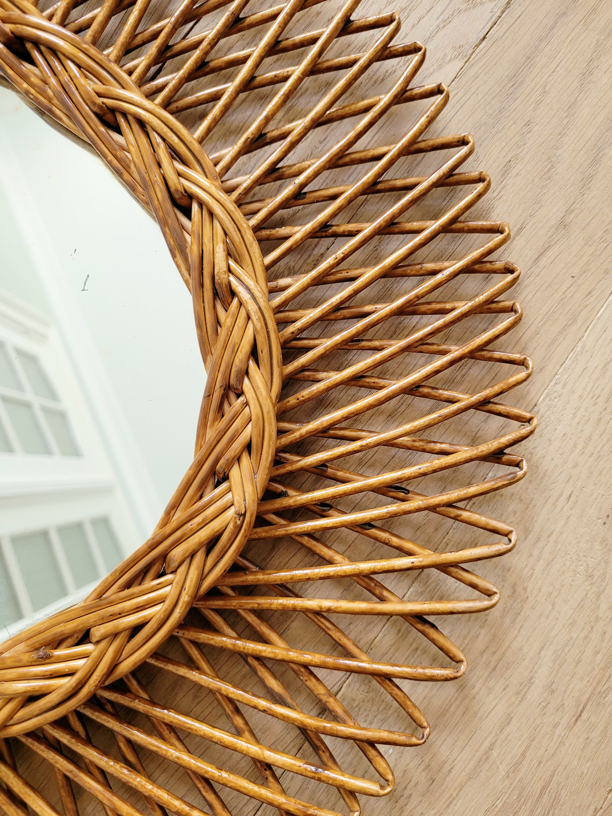 detail of an oval wall mirror in wicker texture