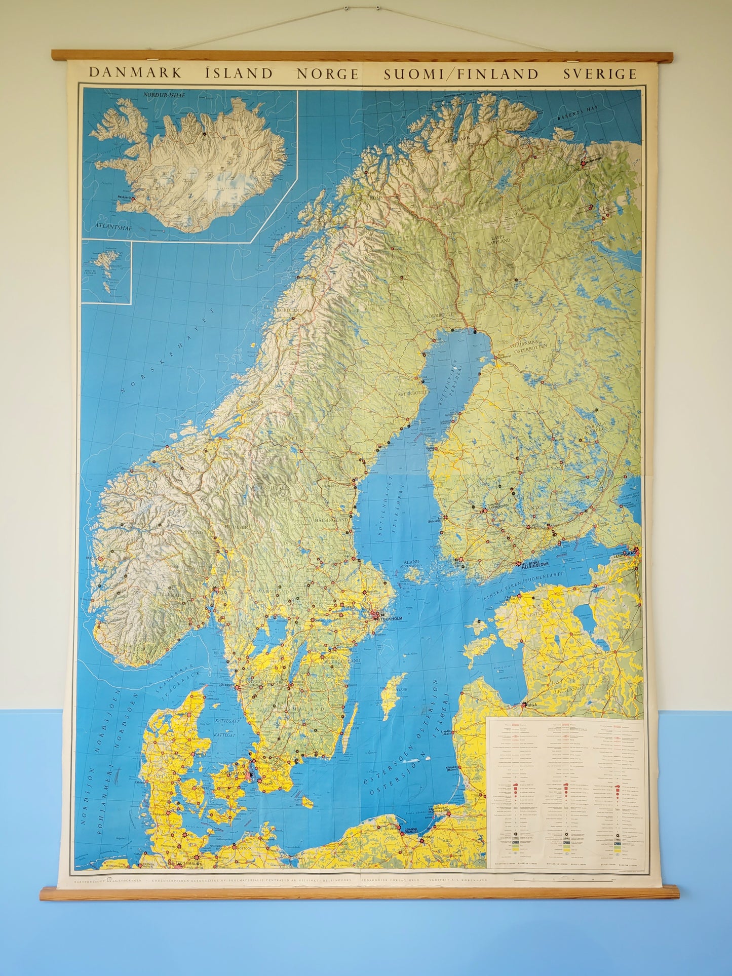 front view of a large historic school map of the Nordic countries hanging on a blue and yellow wall