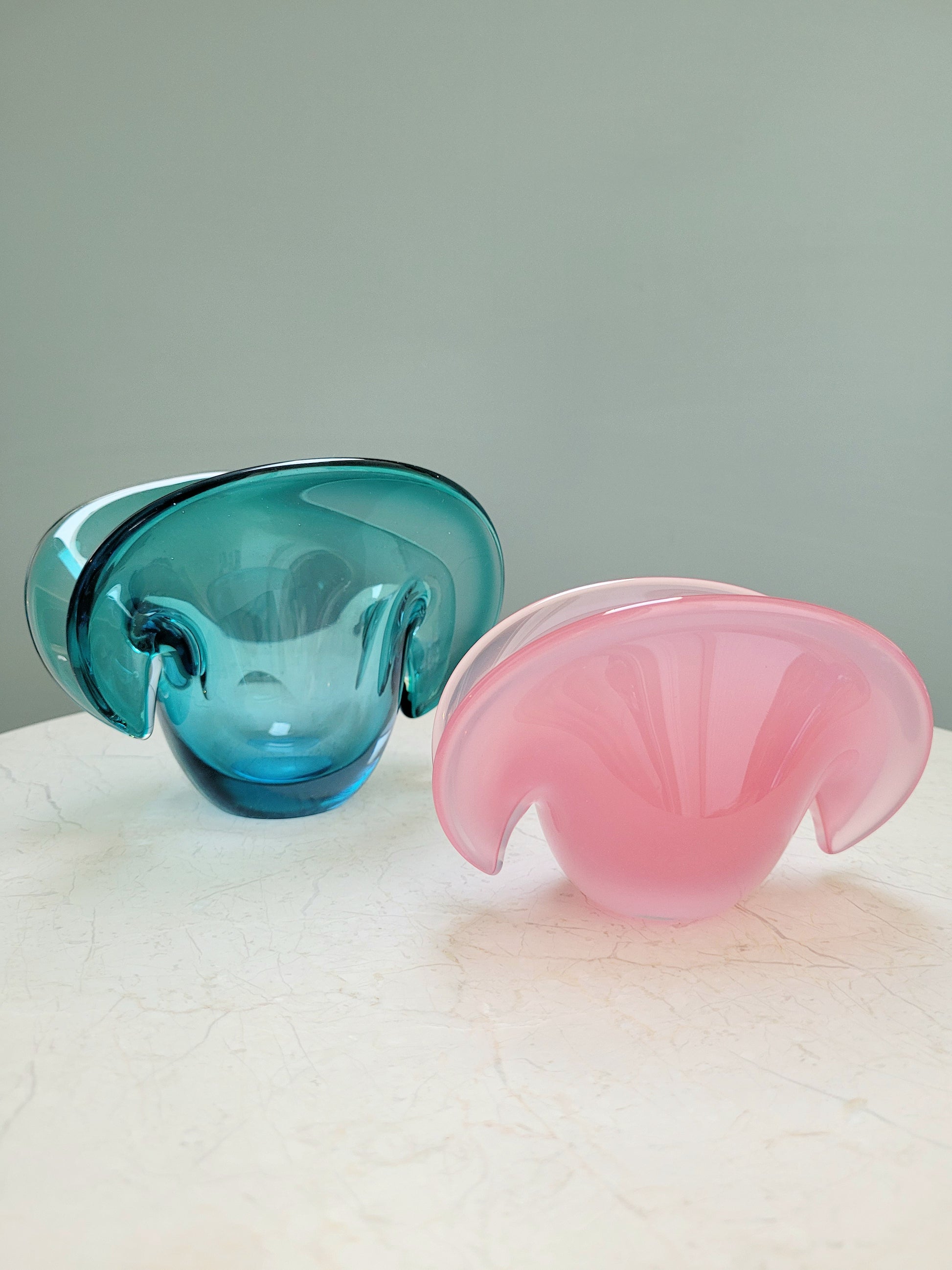 side view of vintage Murano clam bowls in colourful blue and pink 