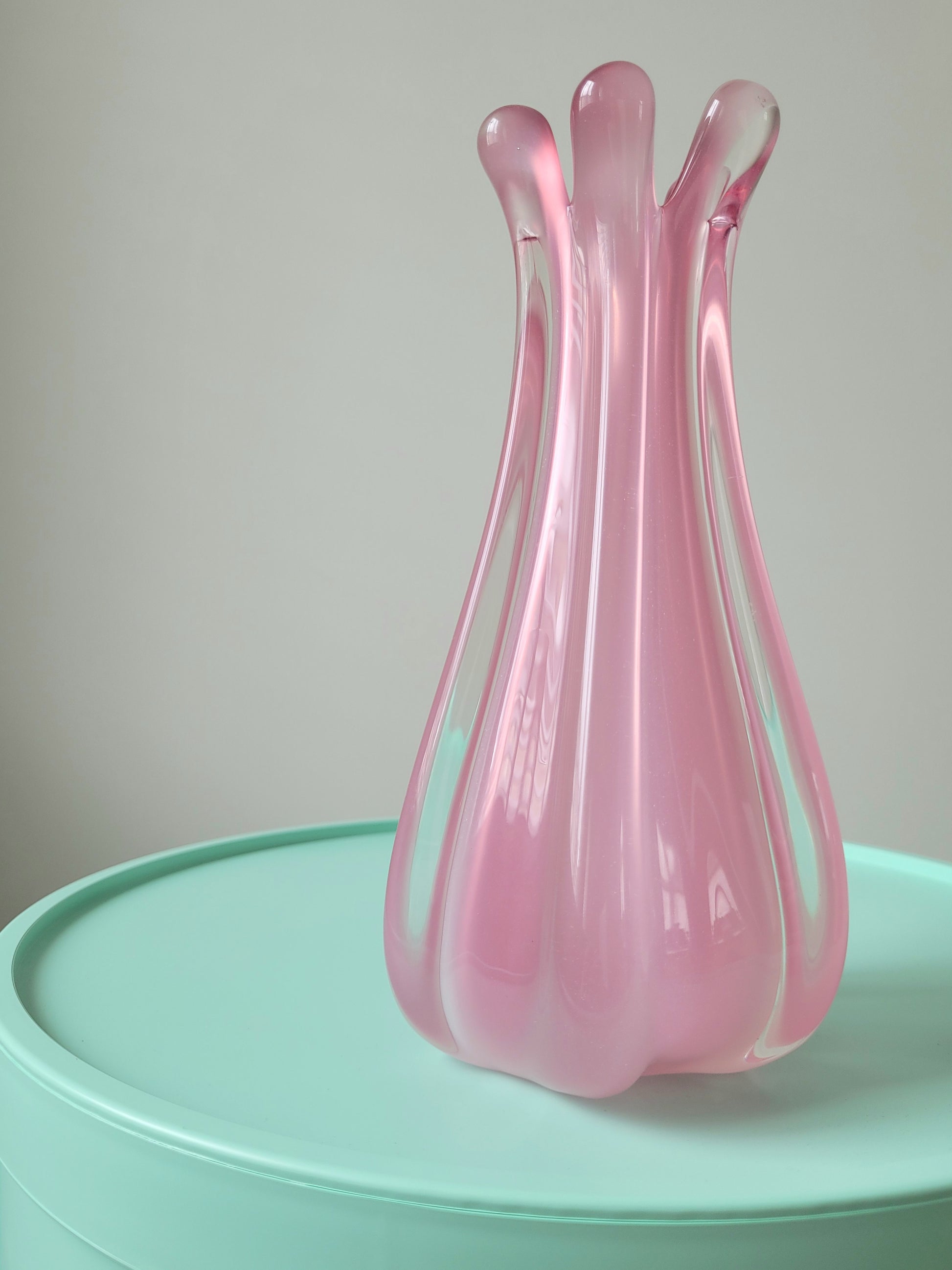 front view of a unique vintage Murano pink hue alabaster vase on a mint green side table