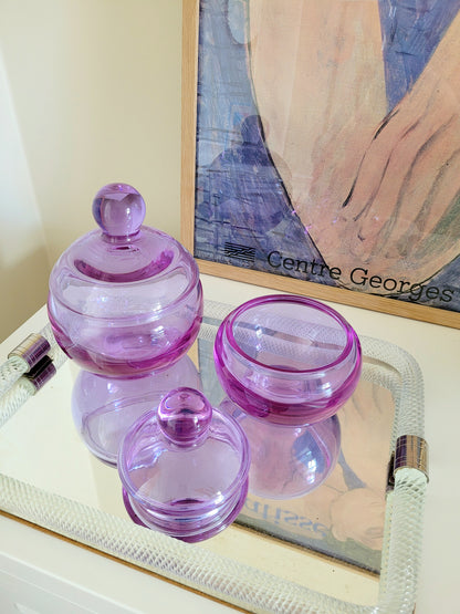 top view of two vintage clear purple Murano bonbonnieres on a Murano mirror tray