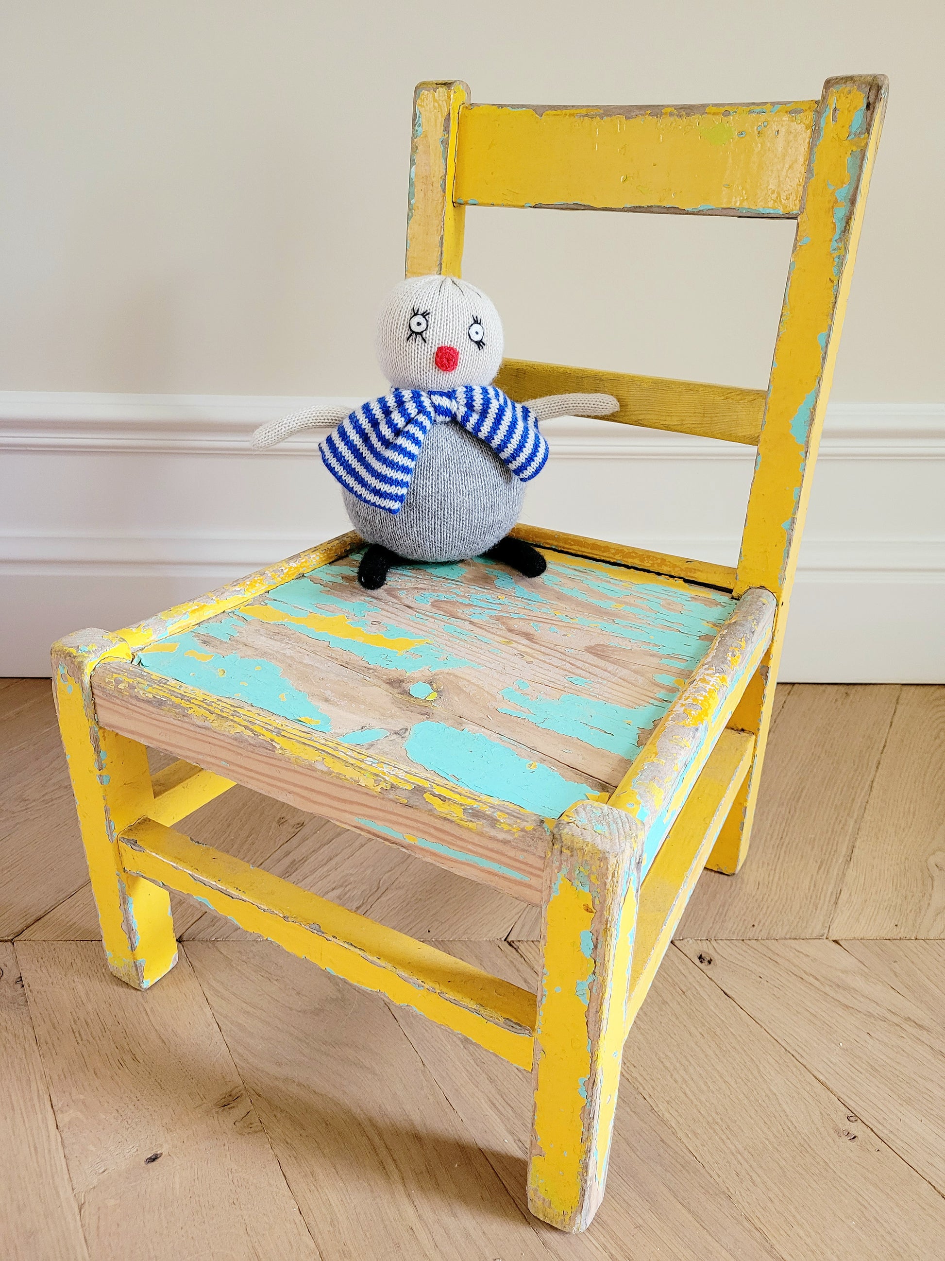 full view of a characterful wooden kids chair in yellow and green with patina