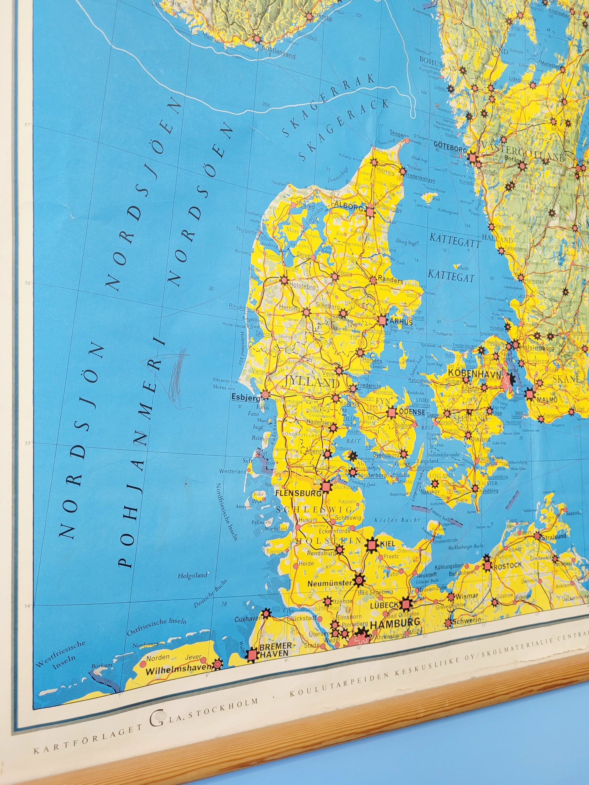 detail of a large historic school map of the Nordic countries hanging on a blue and yellow wall