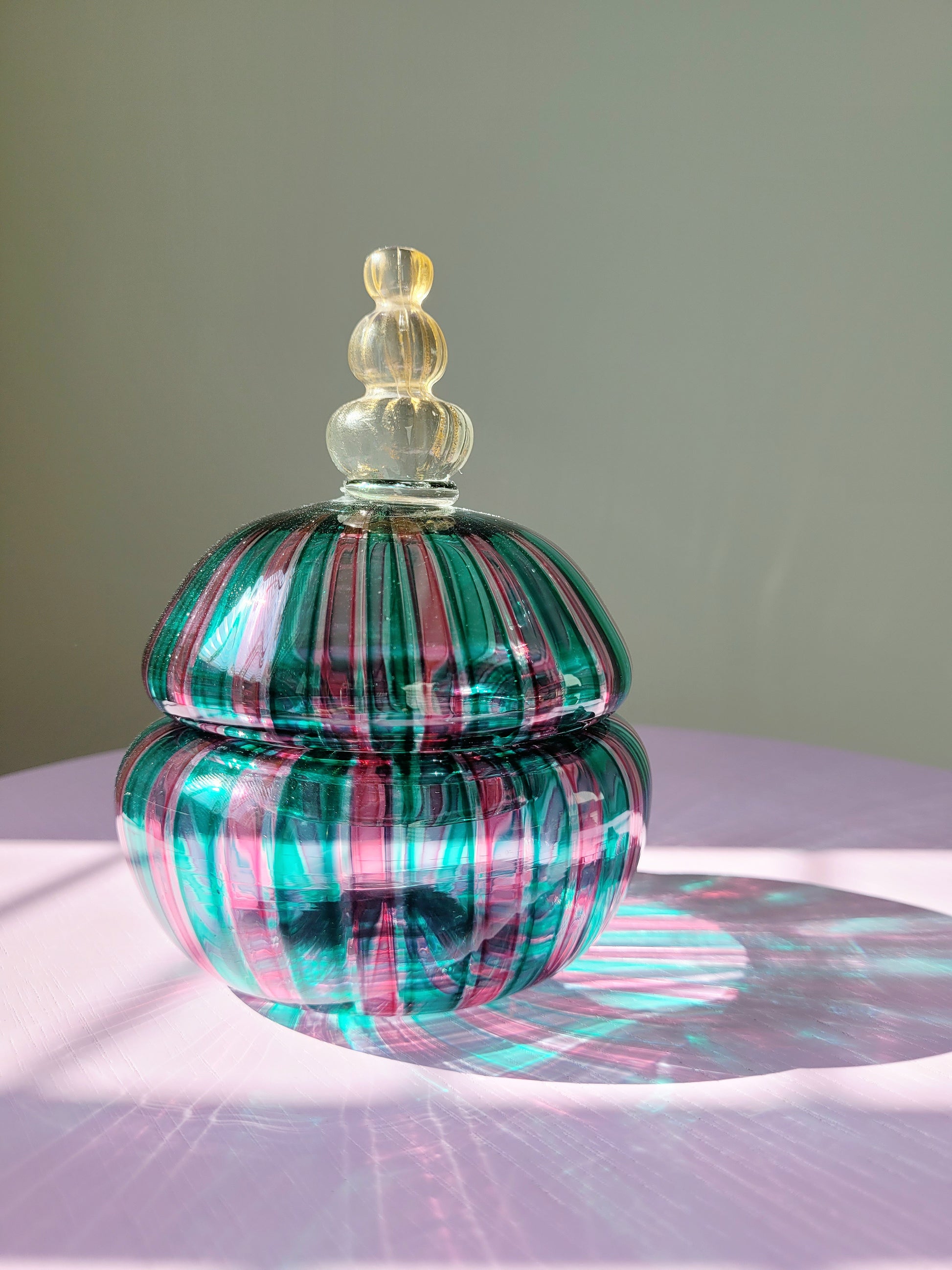 front view of a handcrafted vintage striped Murano bonbonniere 
