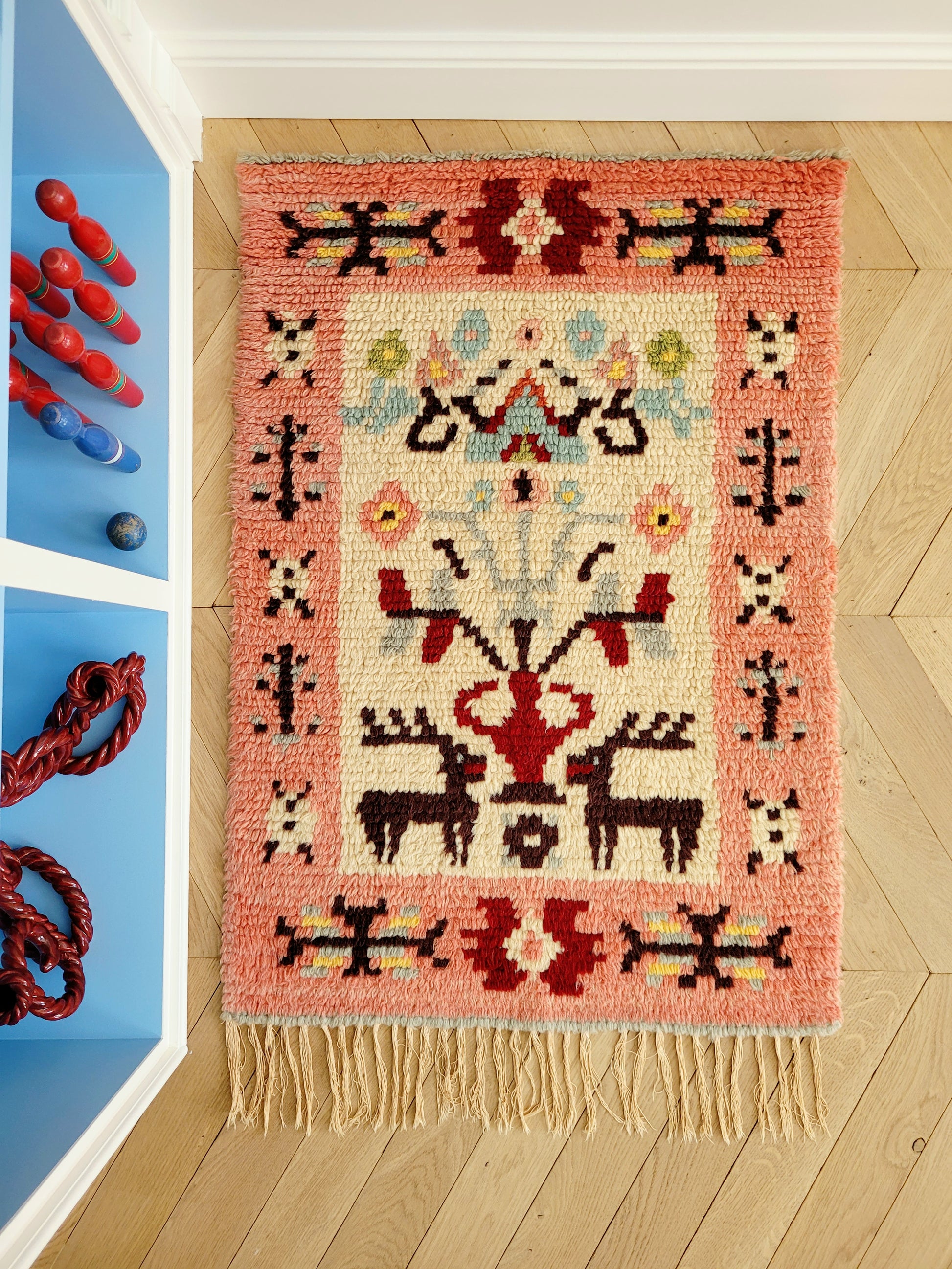 top view of a vintage colourful Scandinavian Rya rug made from wool