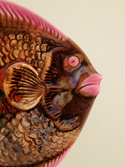detail of a quirky ceramic serving bowl in fish shape in purple pink and brown