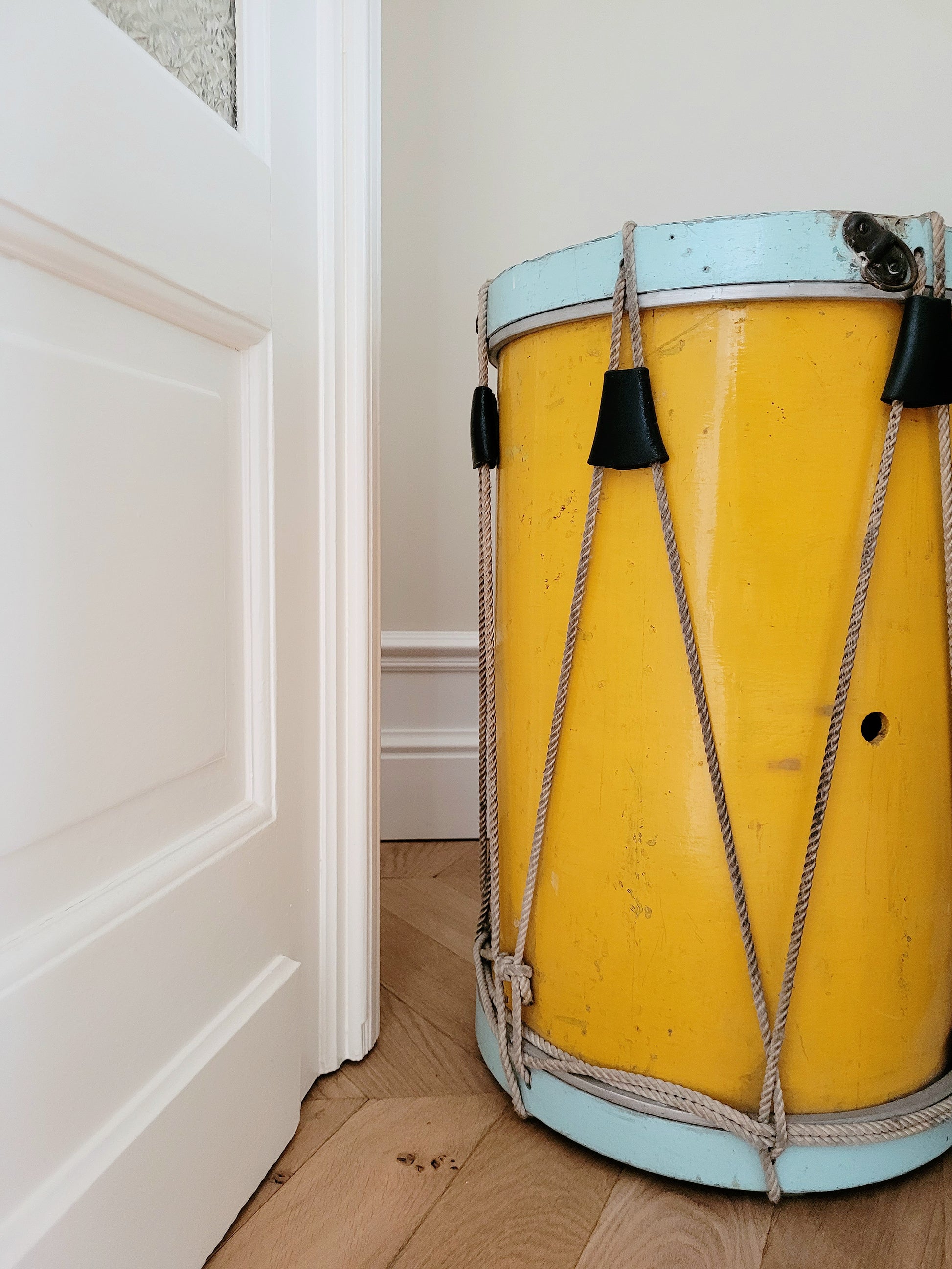 detail of a colourful rope tension drum in vibrant colours in use as a side table