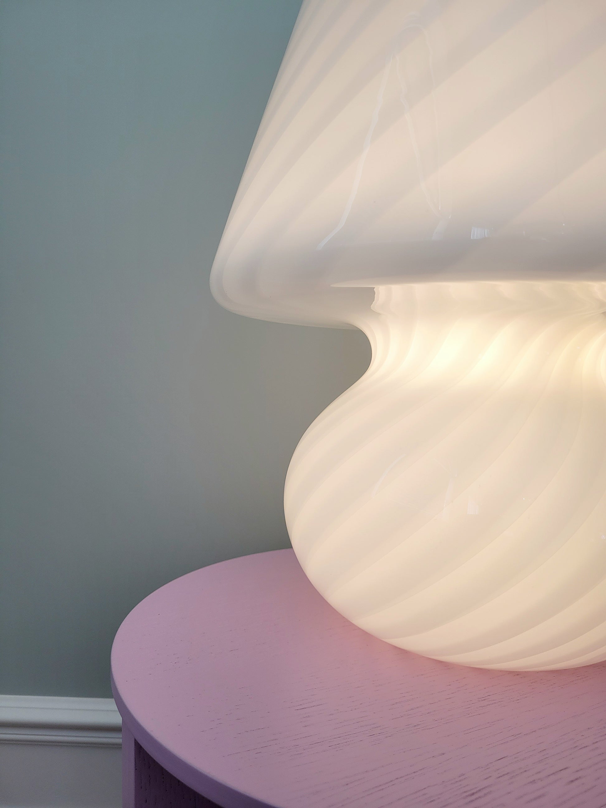 detail of an extra large vintage Murano white swirl mushroom lamp illuminated