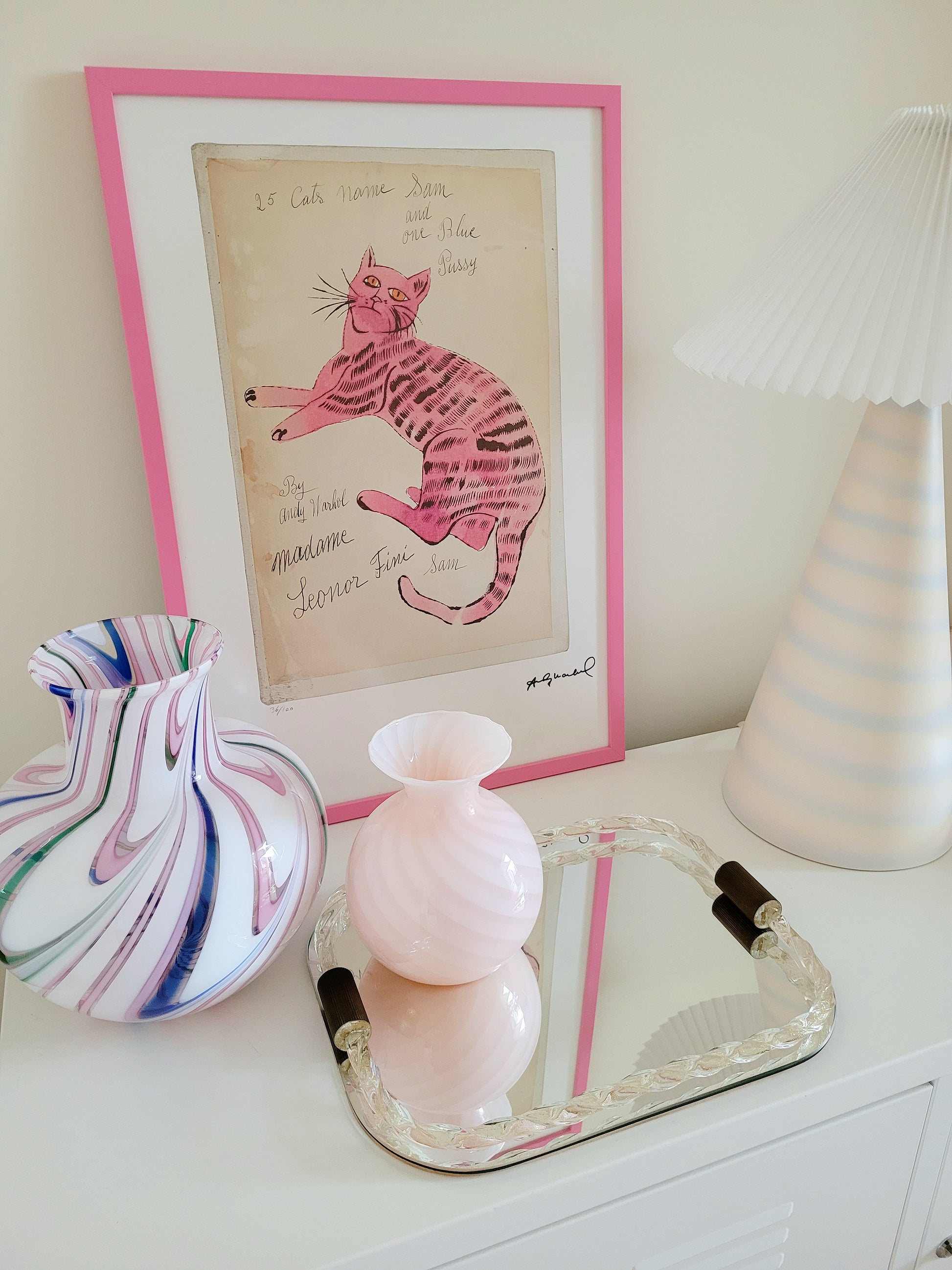 front view of the lithograph cat Sam by Andy Warholl in a pink frame
