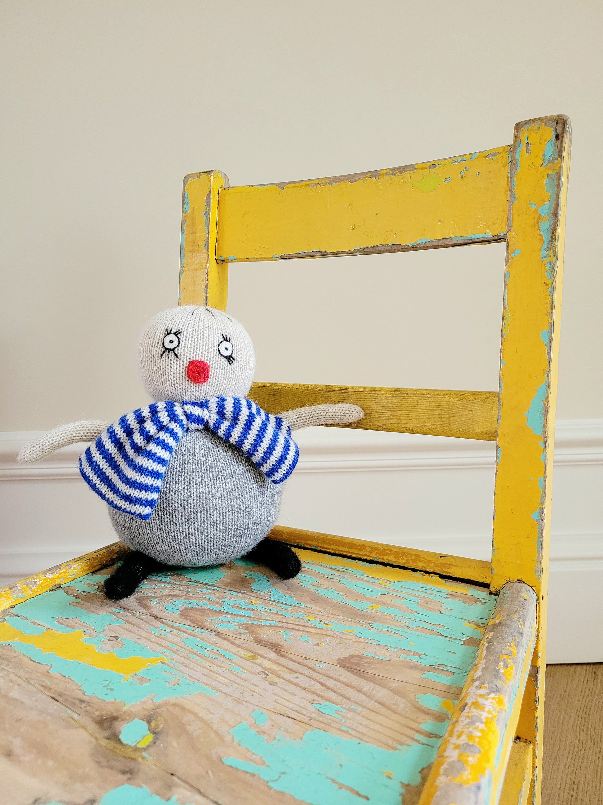 detail of a characterful wooden kids chair in yellow and green with patina