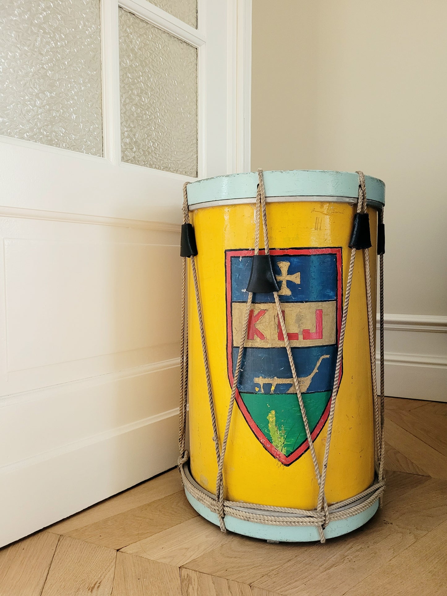 rear view of a colourful rope tension drum in vibrant colours in use as a side table