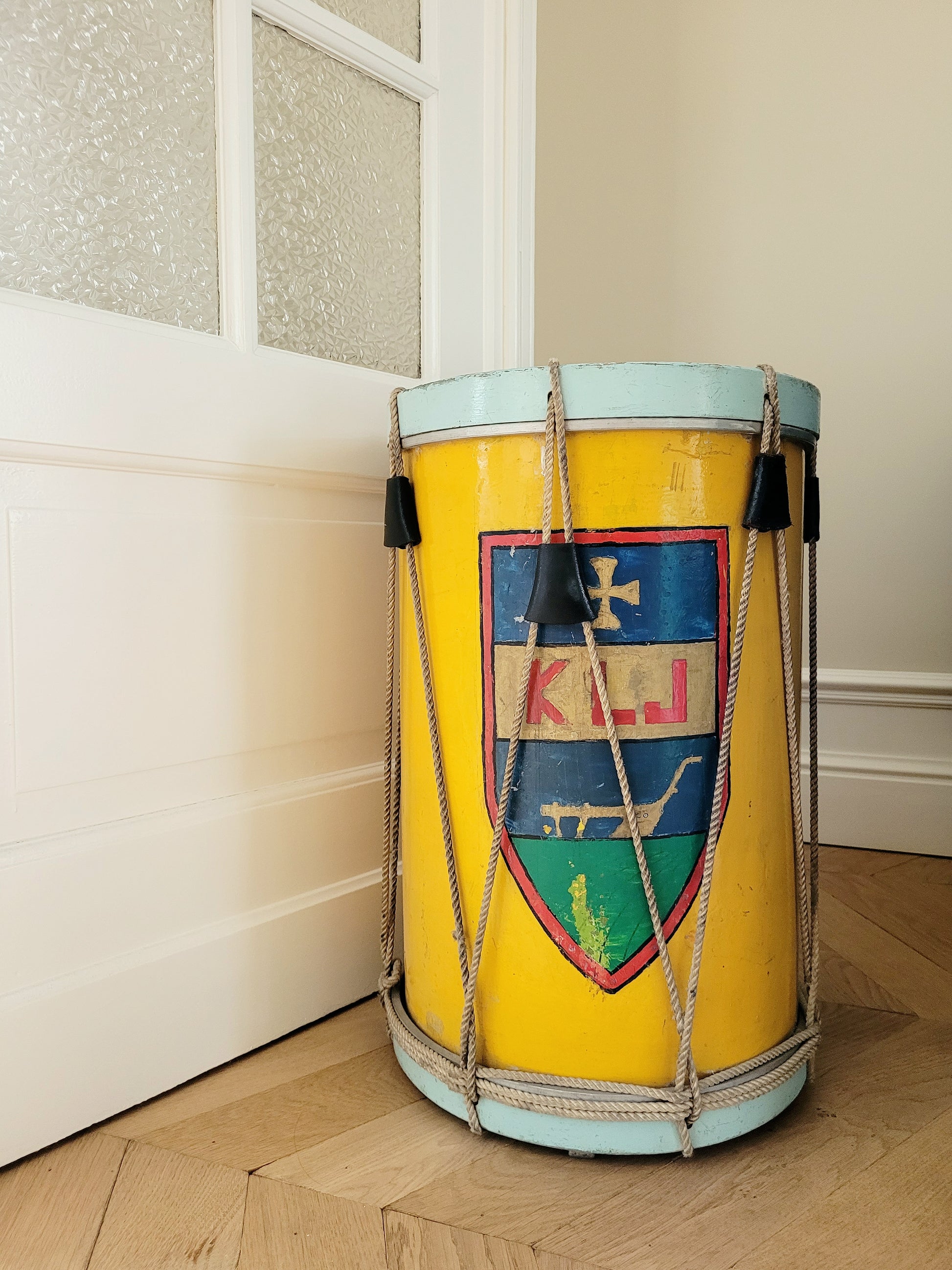 rear view of a colourful rope tension drum in vibrant colours in use as a side table