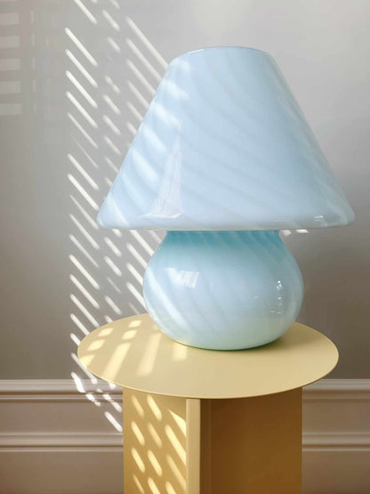 full view of a large vintage Murano blue swirl mushroom lamp on a yellow side table