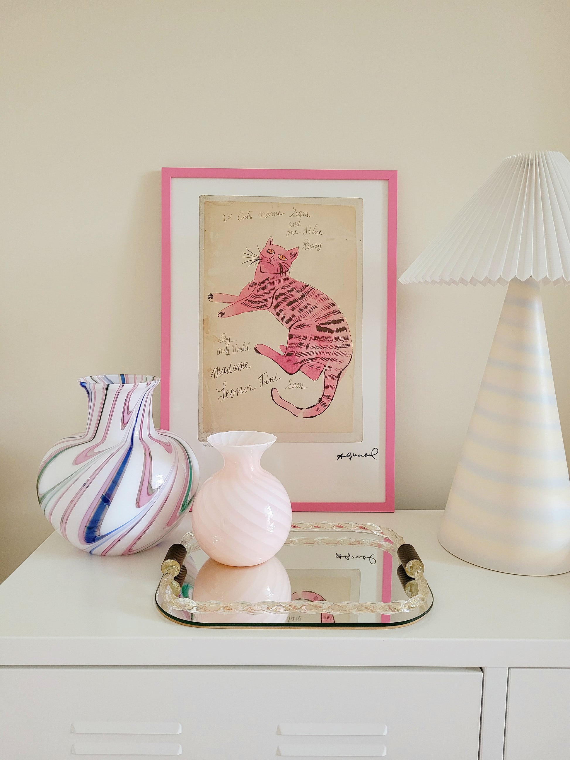 front view of the lithograph cat Sam by Andy Warholl in a pink frame