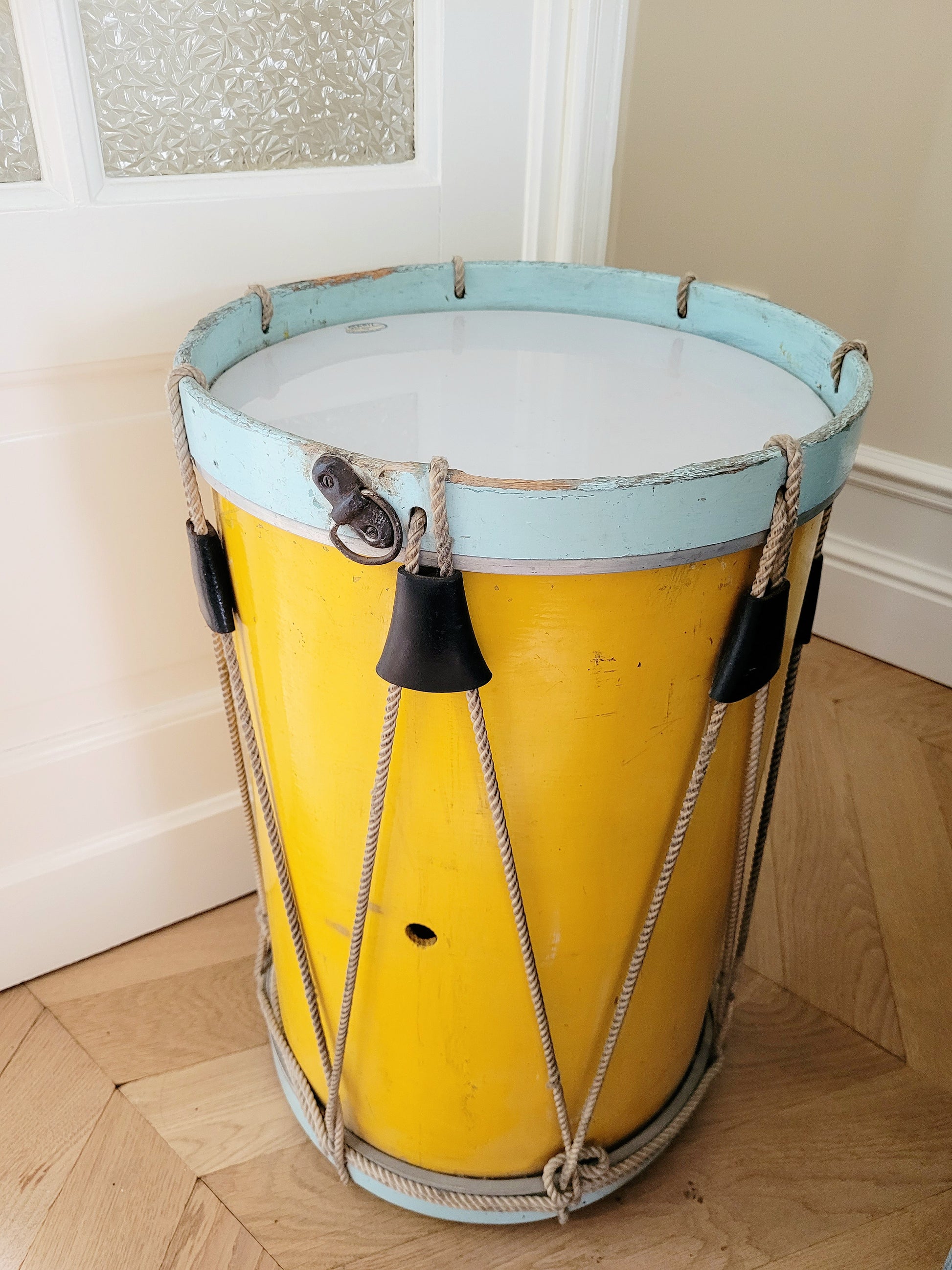 top view of a colourful rope tension drum in vibrant colours in use as a side table