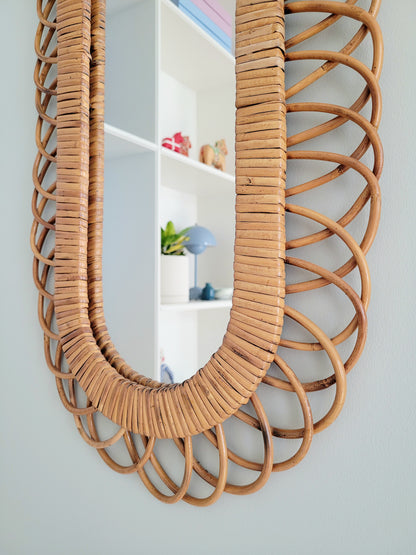 detail of an elongated vintage rattan wall mirror possibly from Franco Albini