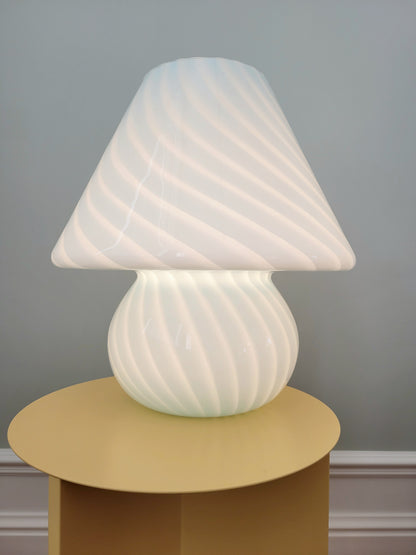 front view of a large vintage Murano blue swirl mushroom lamp illuminated
