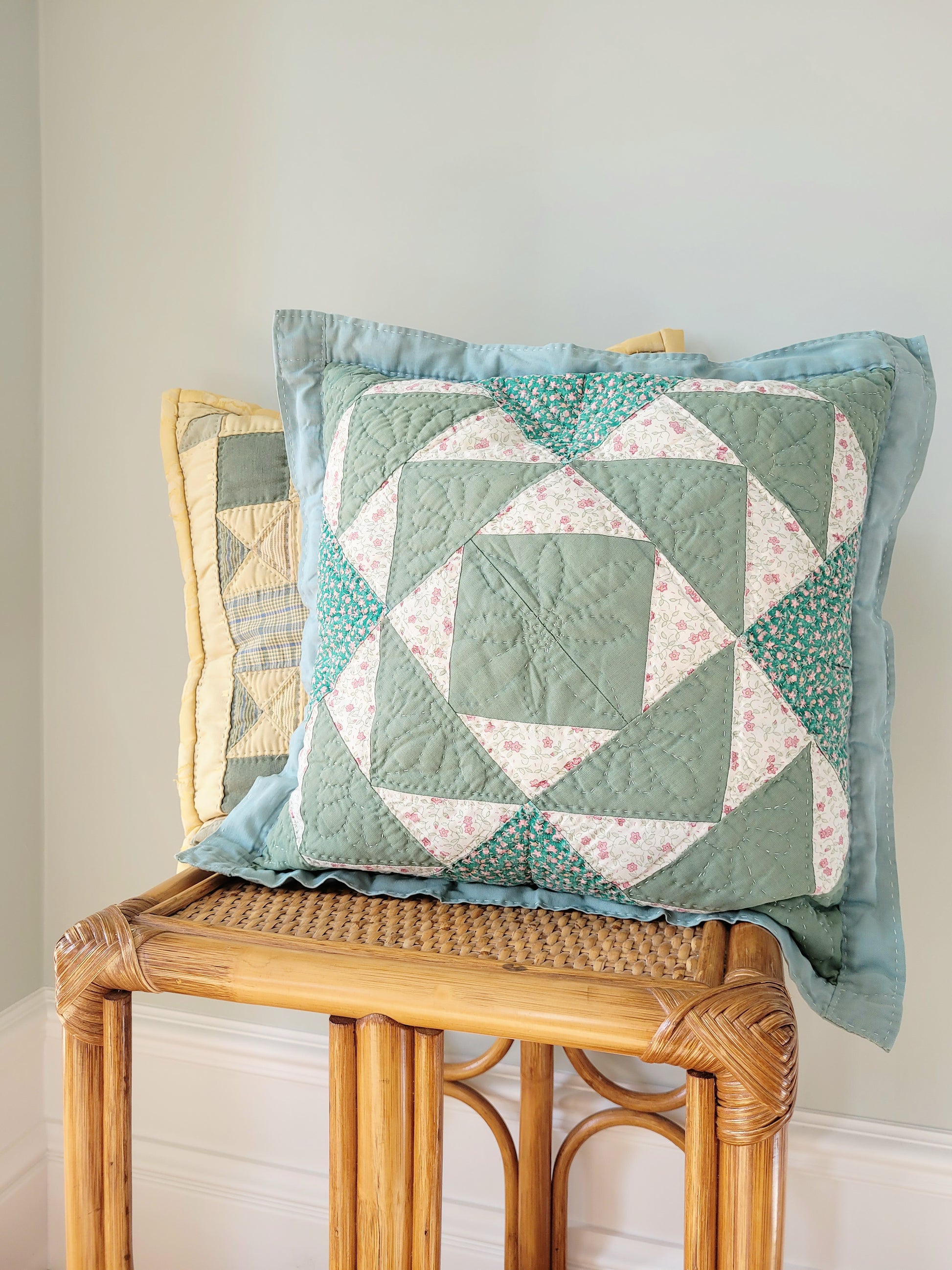 front view of quilted cushions in green and yellow hues and pattern