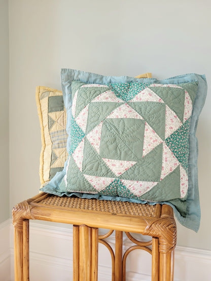 front view of quilted cushions in green and yellow hues and pattern