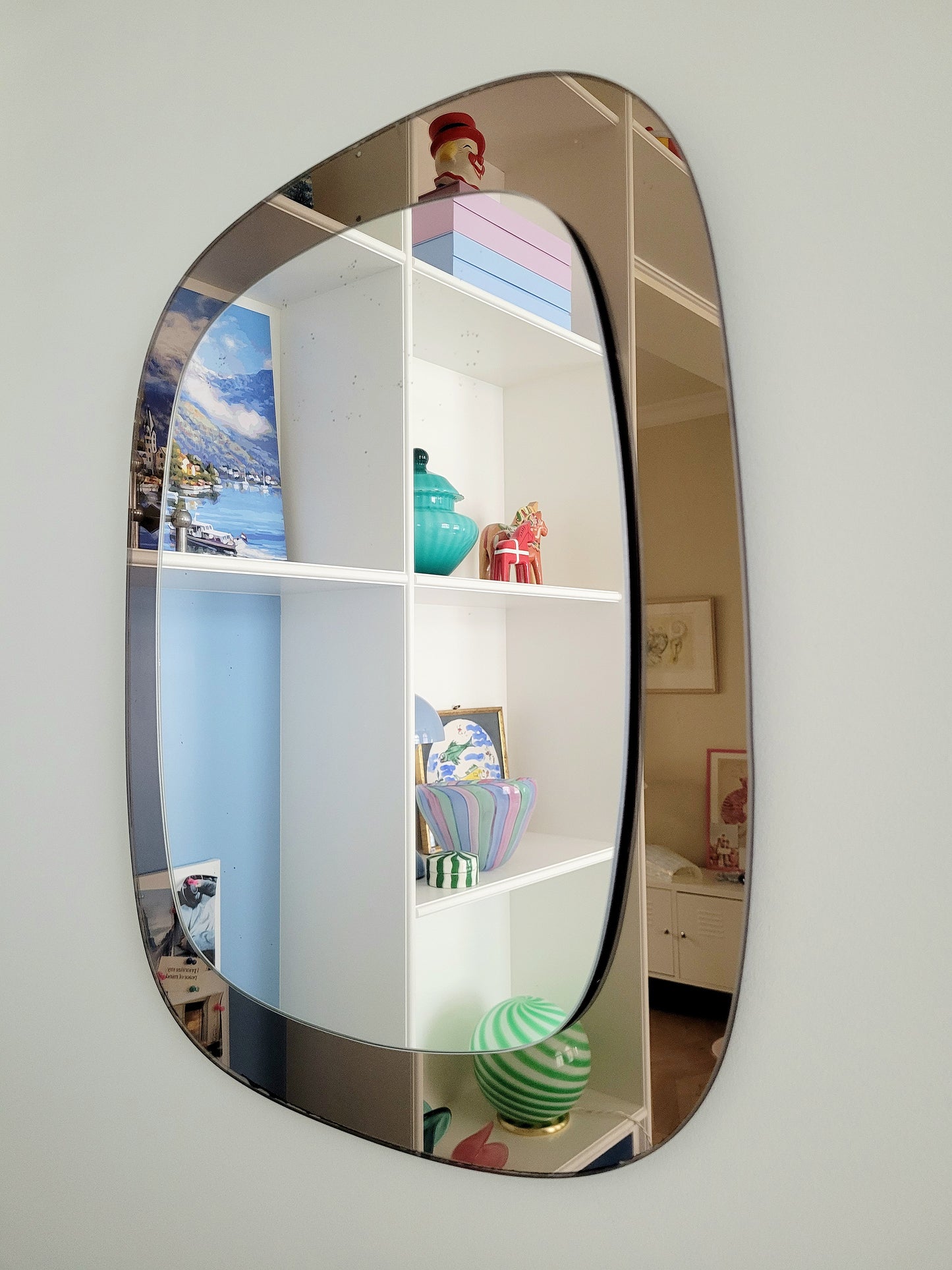full view of a vintage two-tone Italian wall mirror with smoked glass