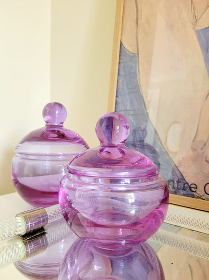 detail of two vintage clear purple Murano bonbonnieres on a Murano mirror tray