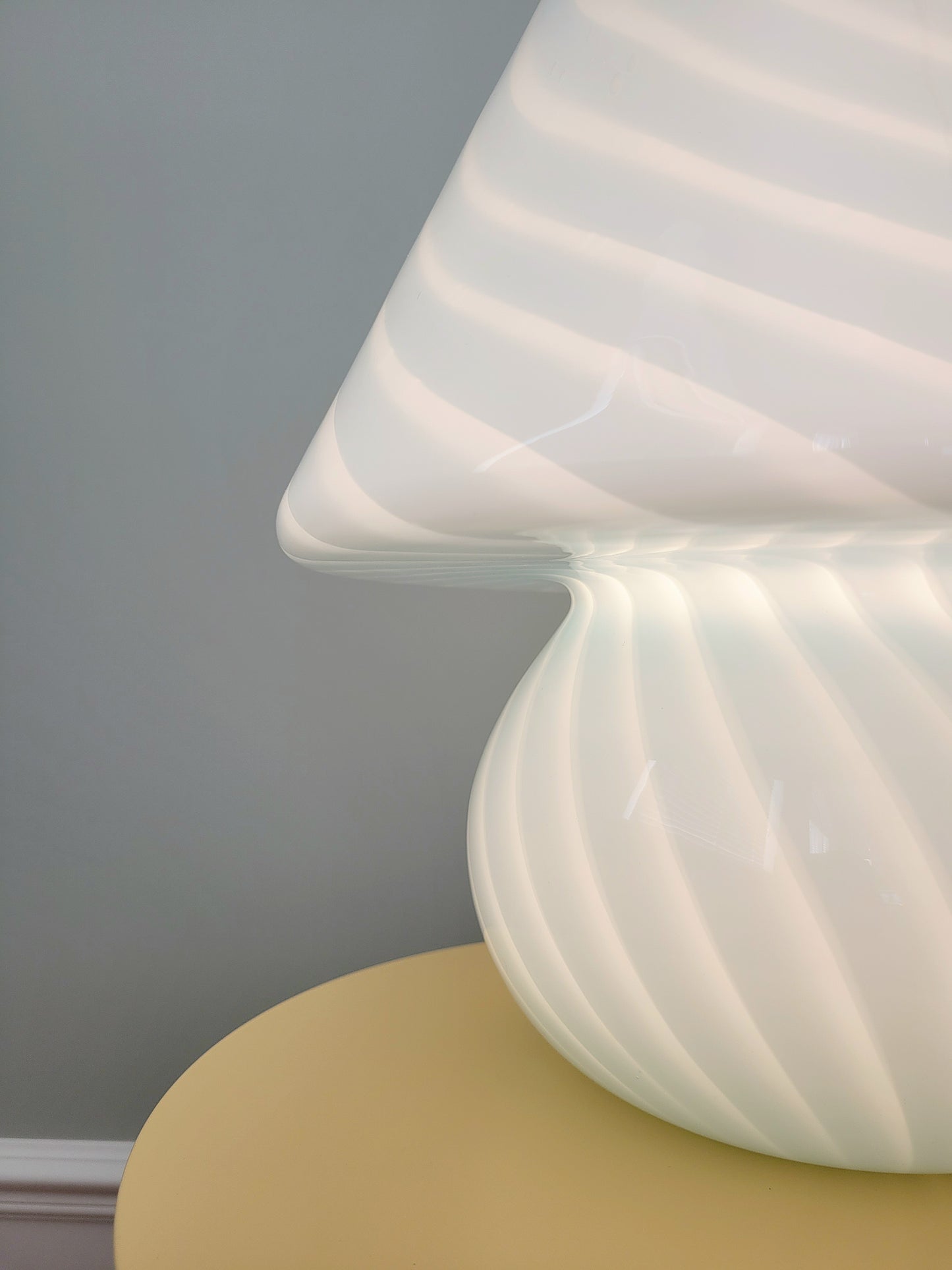 detail of a large vintage Murano blue swirl mushroom lamp illuminated