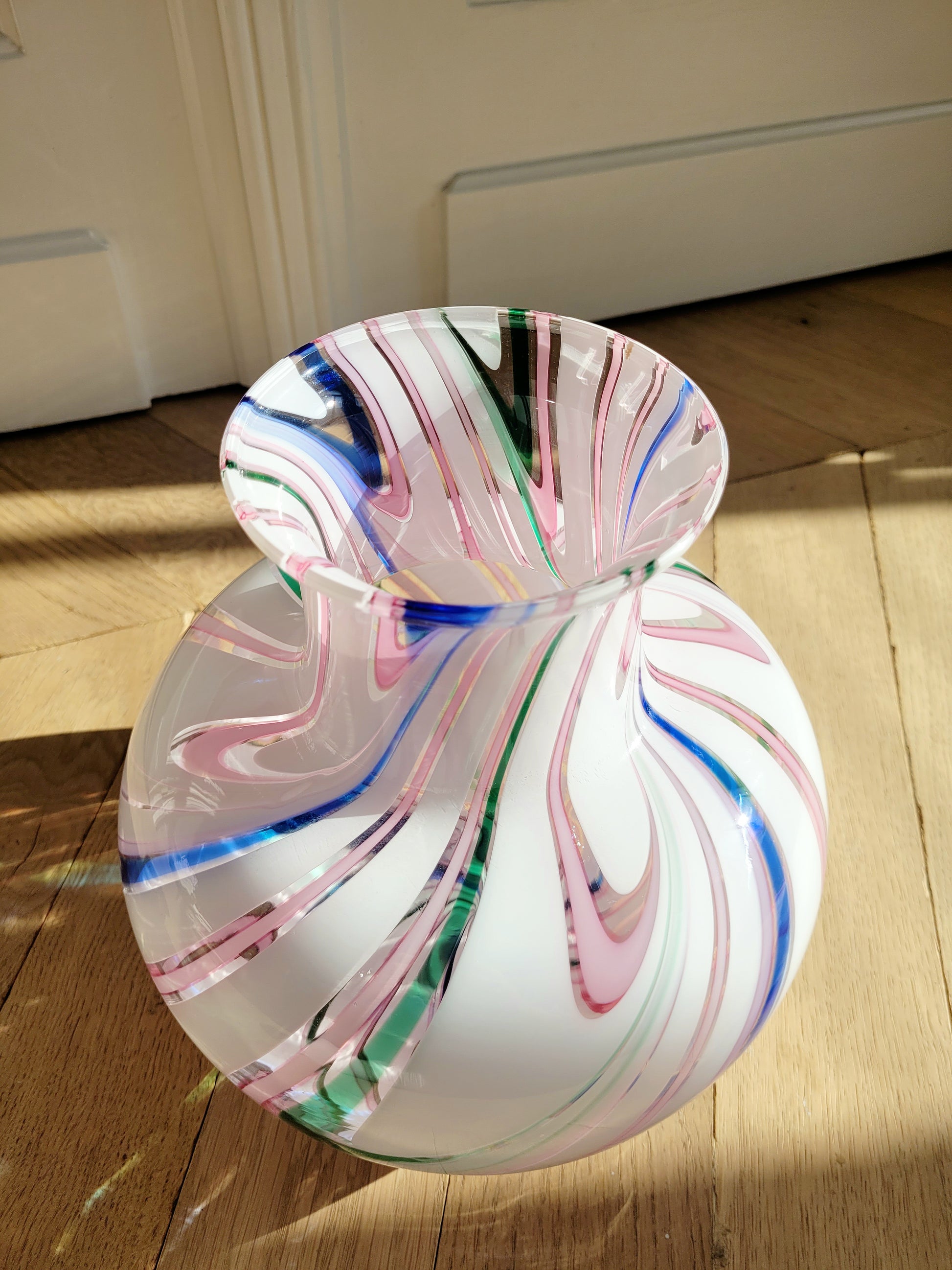 side view of a vintage Michielotto Murano multi swirl vase in a multitude of hues