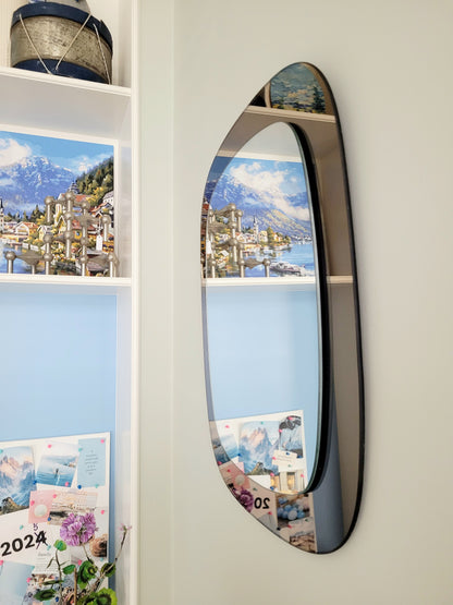 full view of a vintage two-tone Italian wall mirror with smoked glass