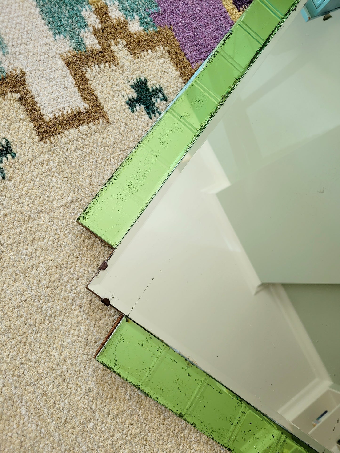 detail of an Art Deco green glass wall mirror