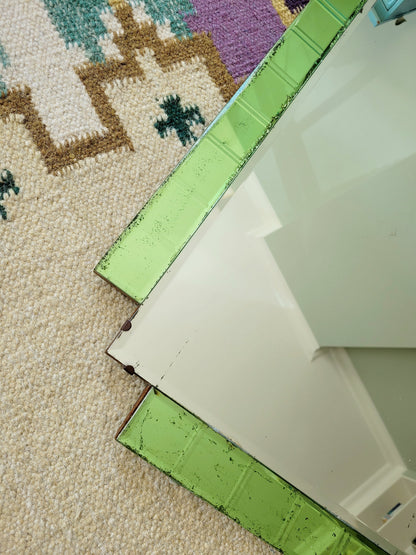 detail of an Art Deco green glass wall mirror