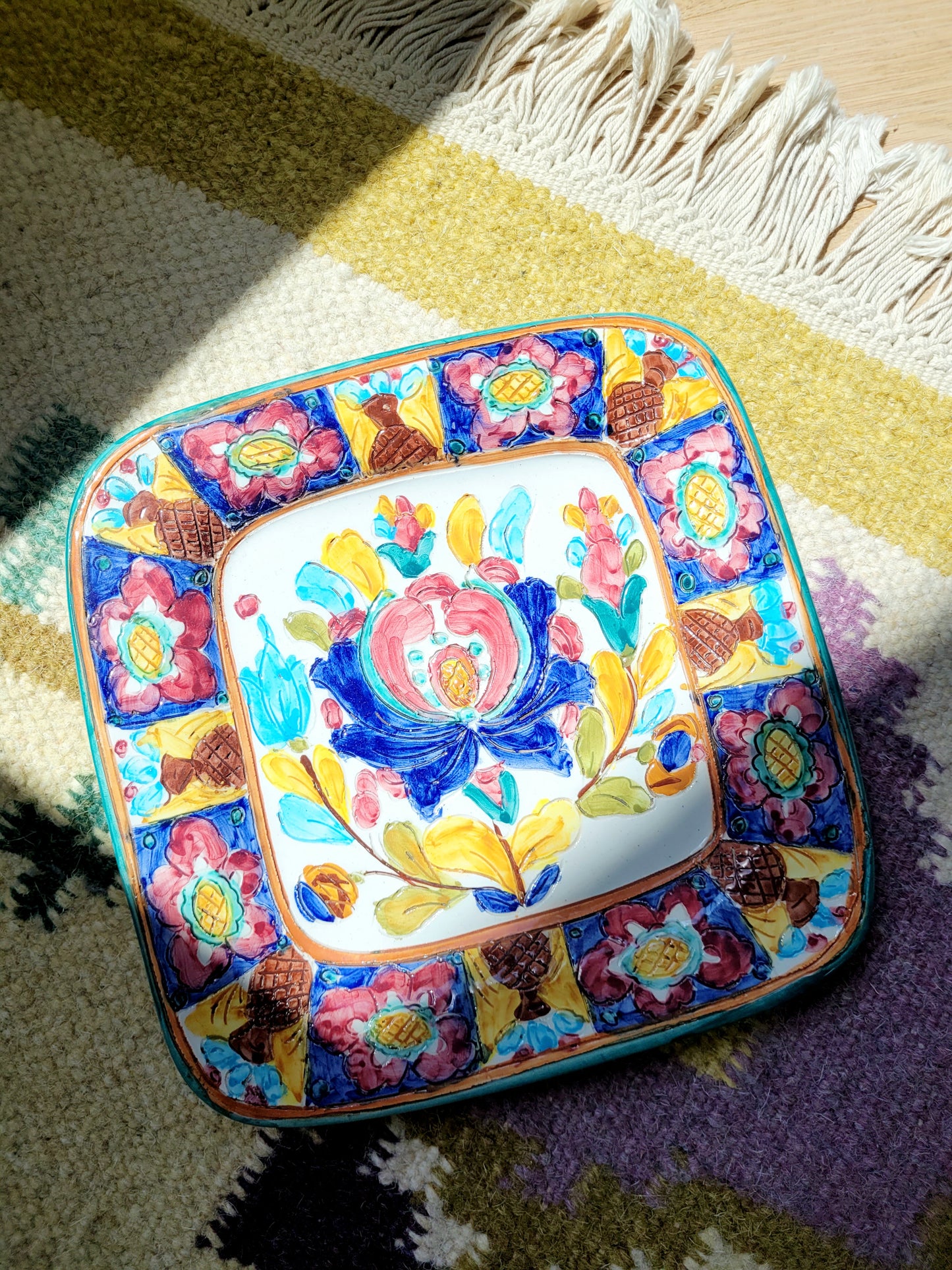 top view of an Italian Deruta ceramic hand-painted wall plate in vibrant colours