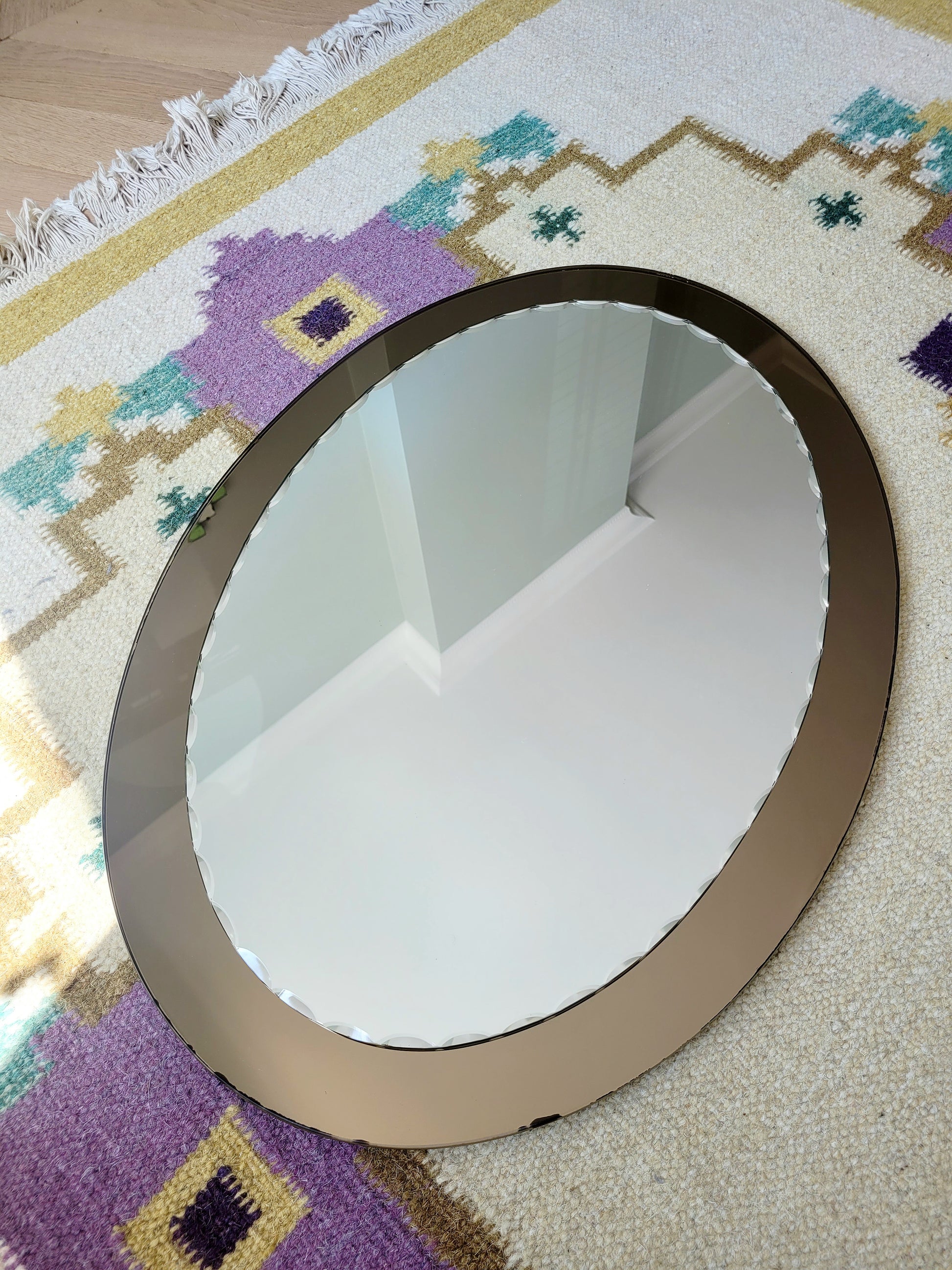 top view of an Italian faceted mirror, featuring a rich brown frame