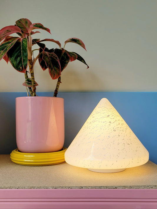A cone-shaped table lamp made from Murano glass with silver flakes running through it