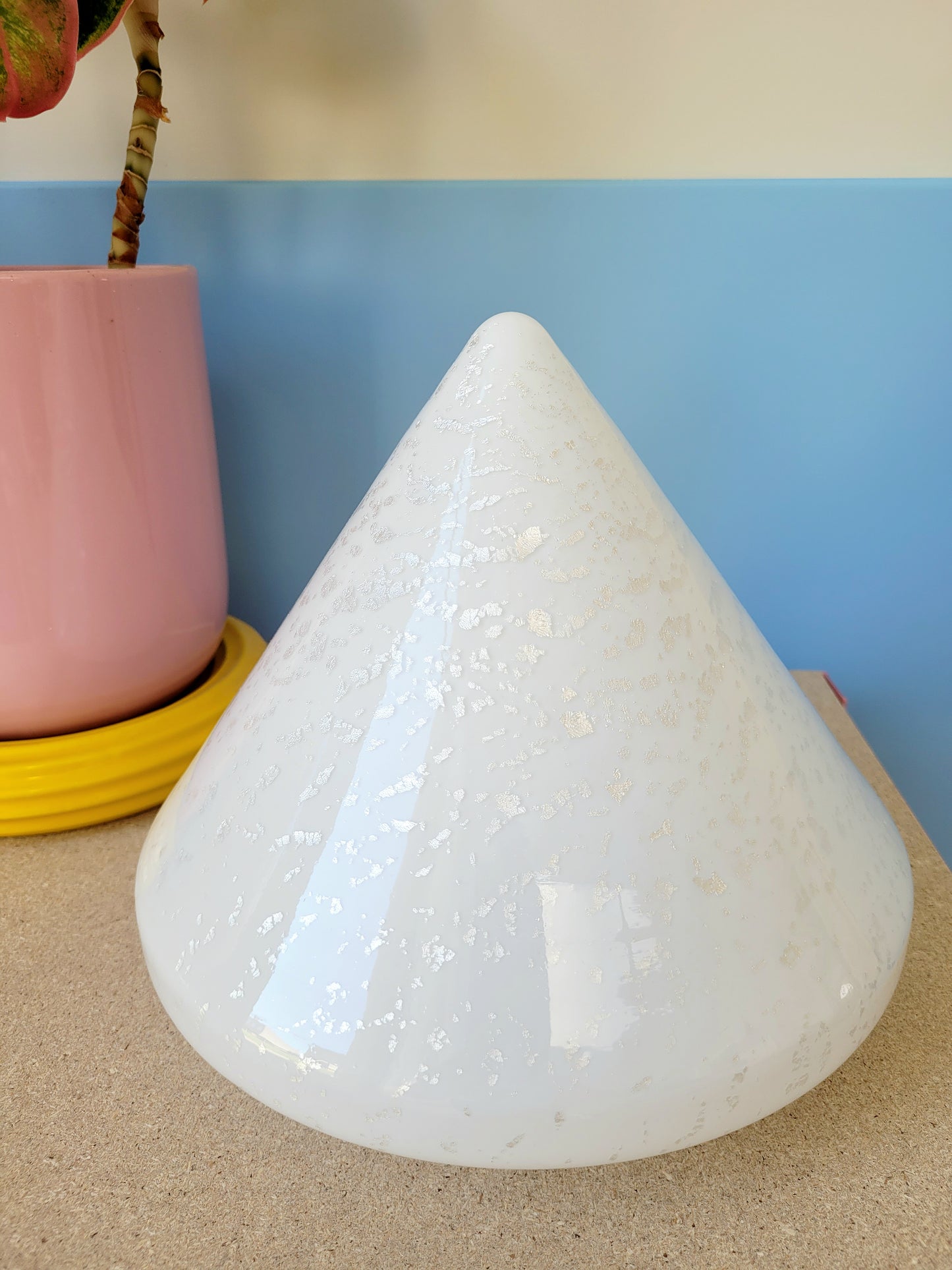 A cone-shaped table lamp made from Murano glass with silver flakes running through it