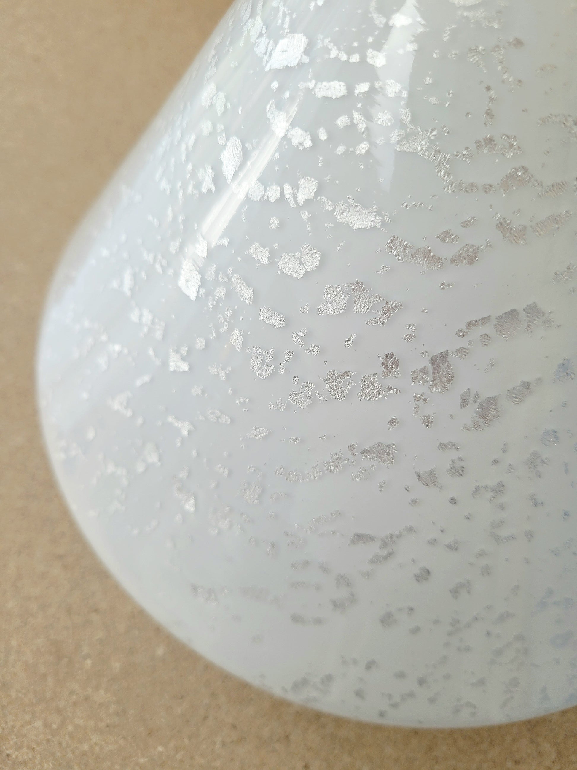 detail of a cone-shaped table lamp made from Murano glass with silver flakes running through it