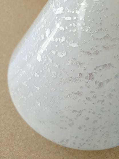detail of a cone-shaped table lamp made from Murano glass with silver flakes running through it